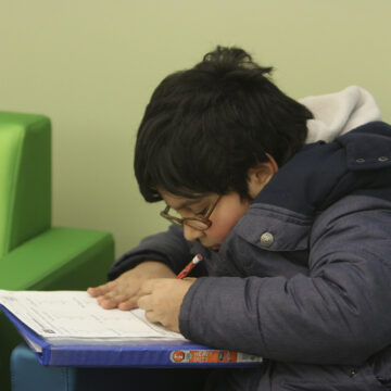 A young boy solving his math homework